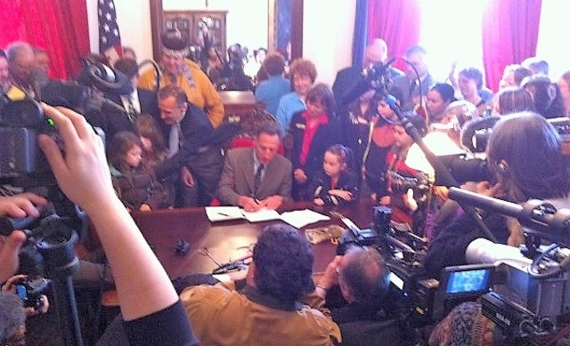 People of all ages gathered in the governor's office will he signes recognition bill into law